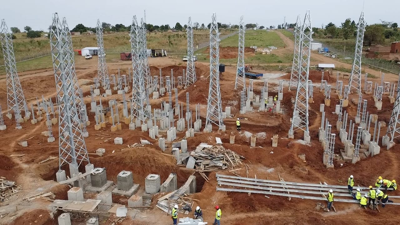Aerial view of substation foundations and gantry towers under construction