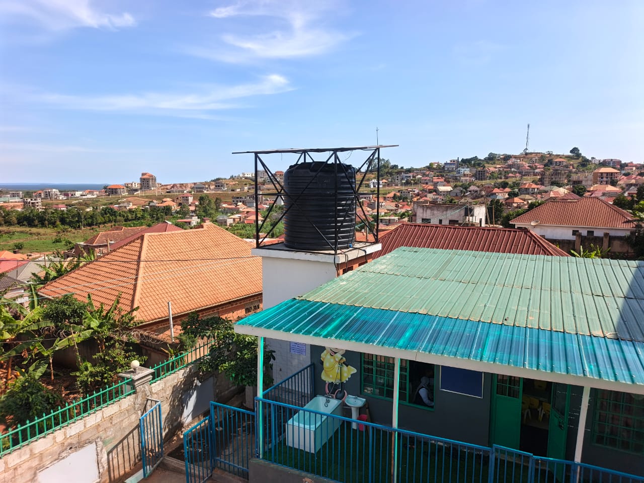 Elevated water tank with overhead solar panels, Ndejje Lubugumu