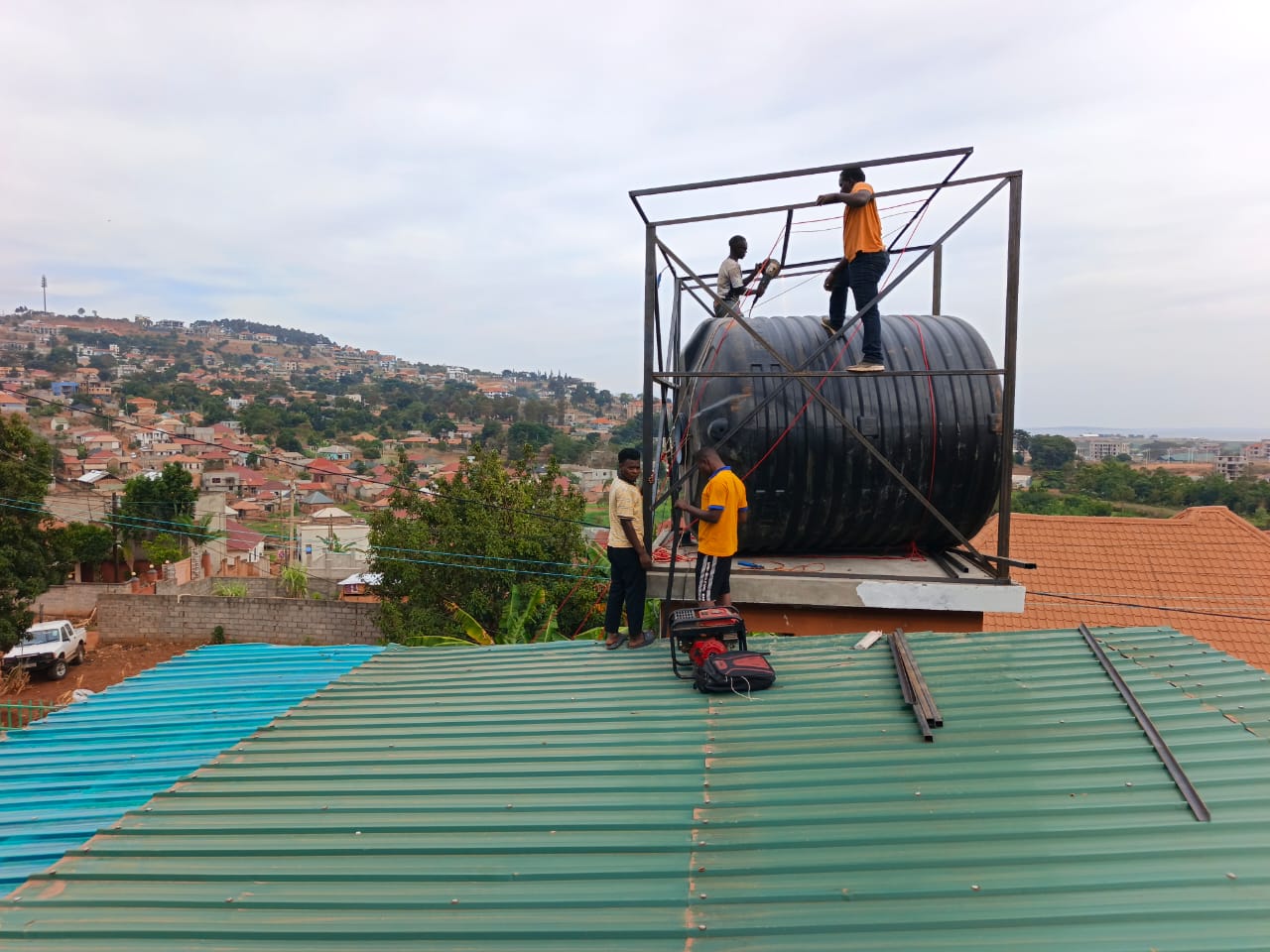Impulsey team installing the water tank and solar mounting frame