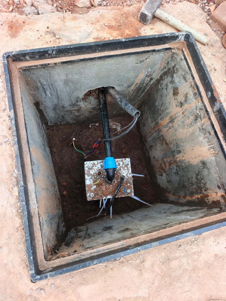 Borehole head chamber with pump outlet and cabling, Ndejje Lubugumu