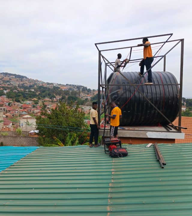 Impulsey team installing the water tank and solar mounting frame